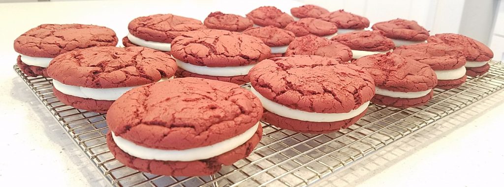 Easy Red Velvet Sandwich Cookies sitting on a cooling rack