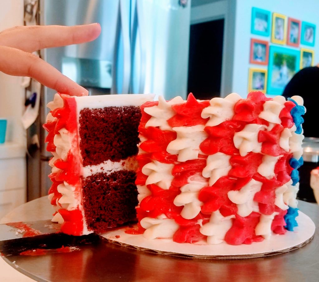 American Decadent Red Velvet Cake being cut